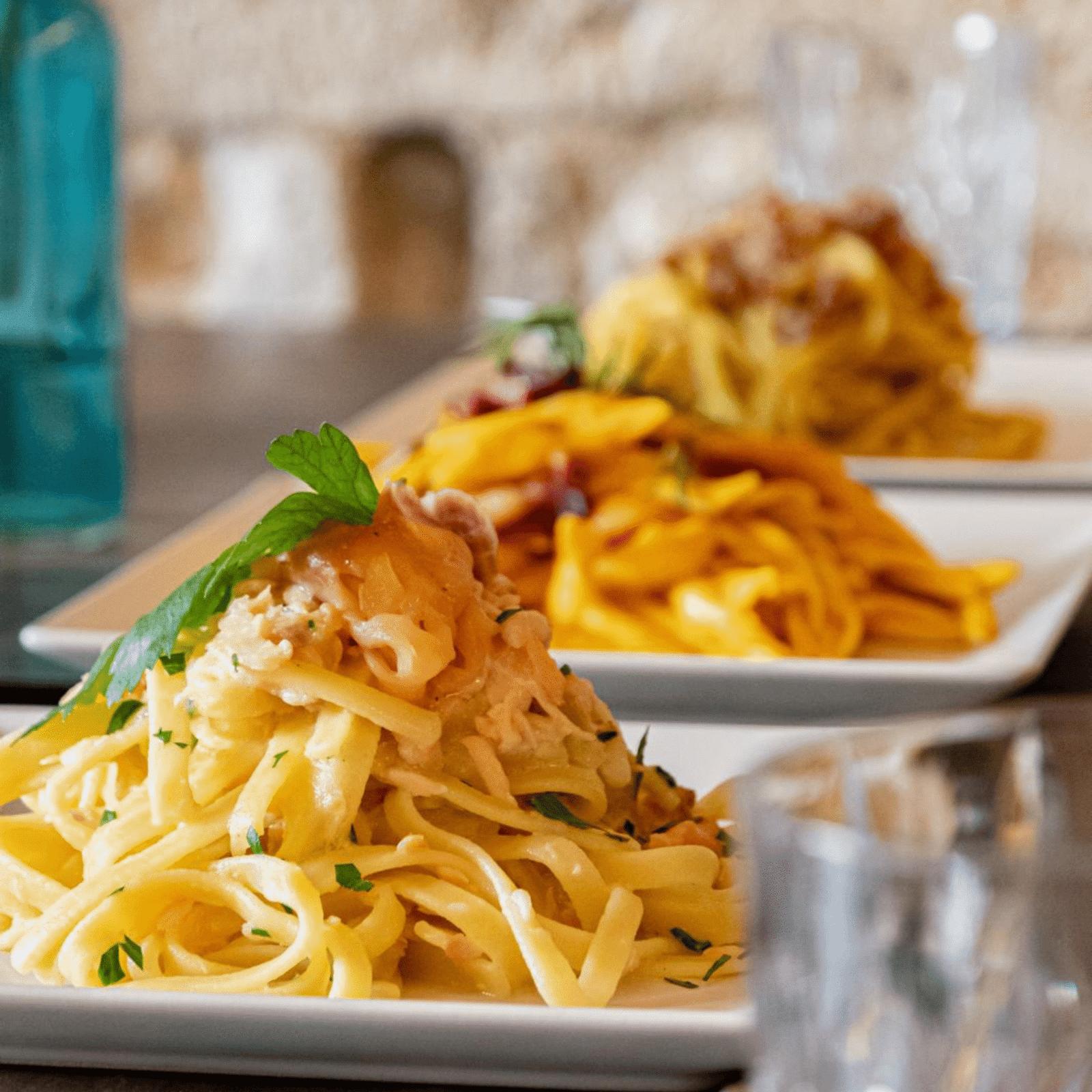Fettuccine with ragù and tonnarelli carbonara, close up